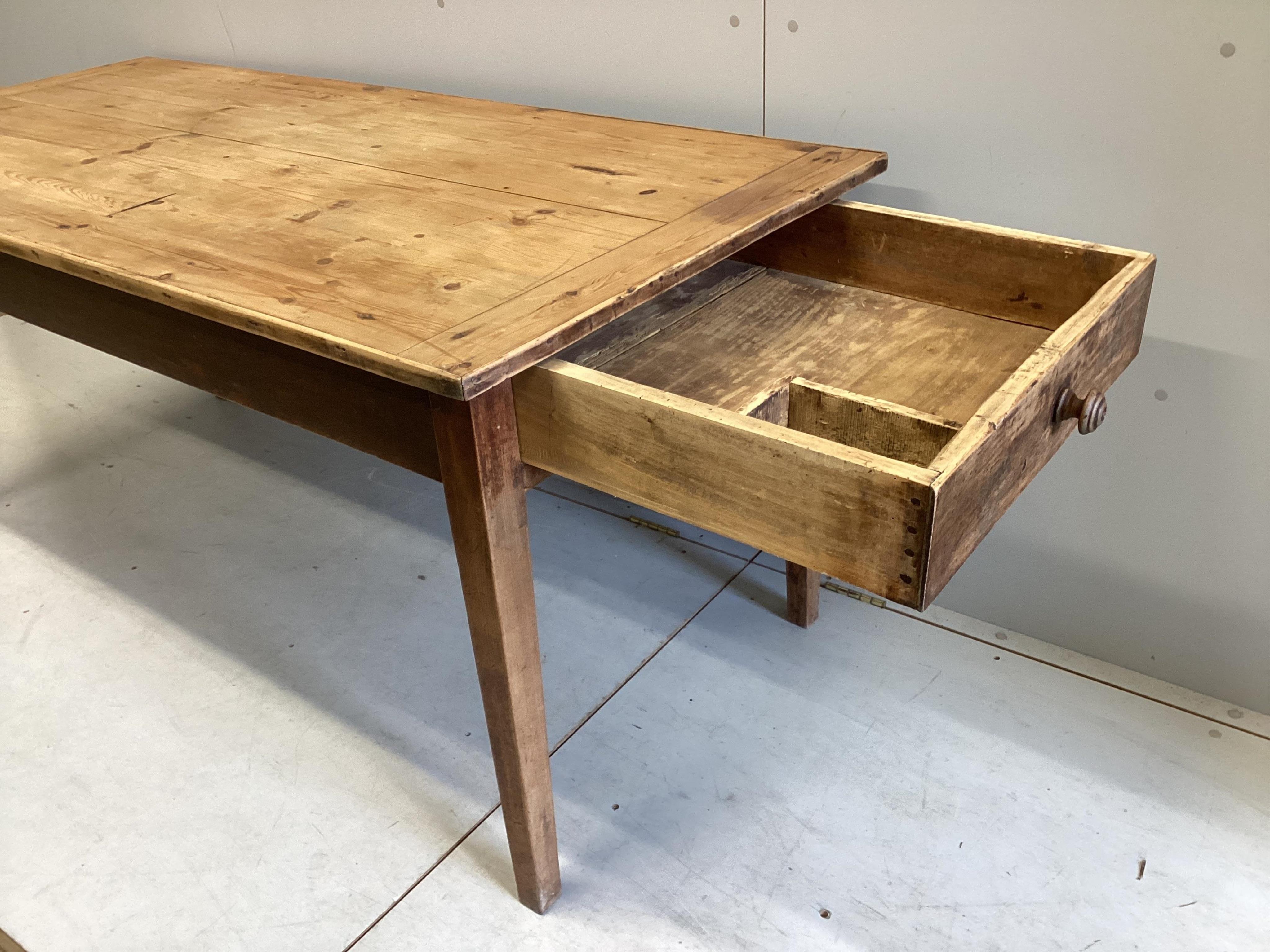 A 19h century French rectangular pine and fruitwood two drawer kitchen table, width 172cm, depth 78cm, height 76cm. Condition - fair, top with slightly opened joints and has traces of old worm.